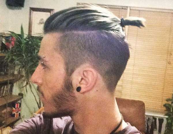 Image of Slicked back top knot men's long hairstyle