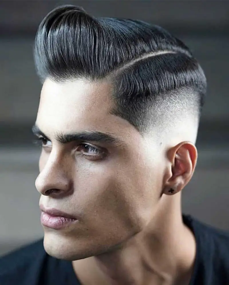 Deep Parted Pompadour with Fade-30 Pompadour Haircut Ideas For Modern Men + Styling Guide
